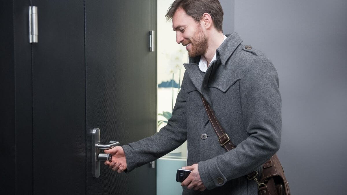 Man opening door with smartphone