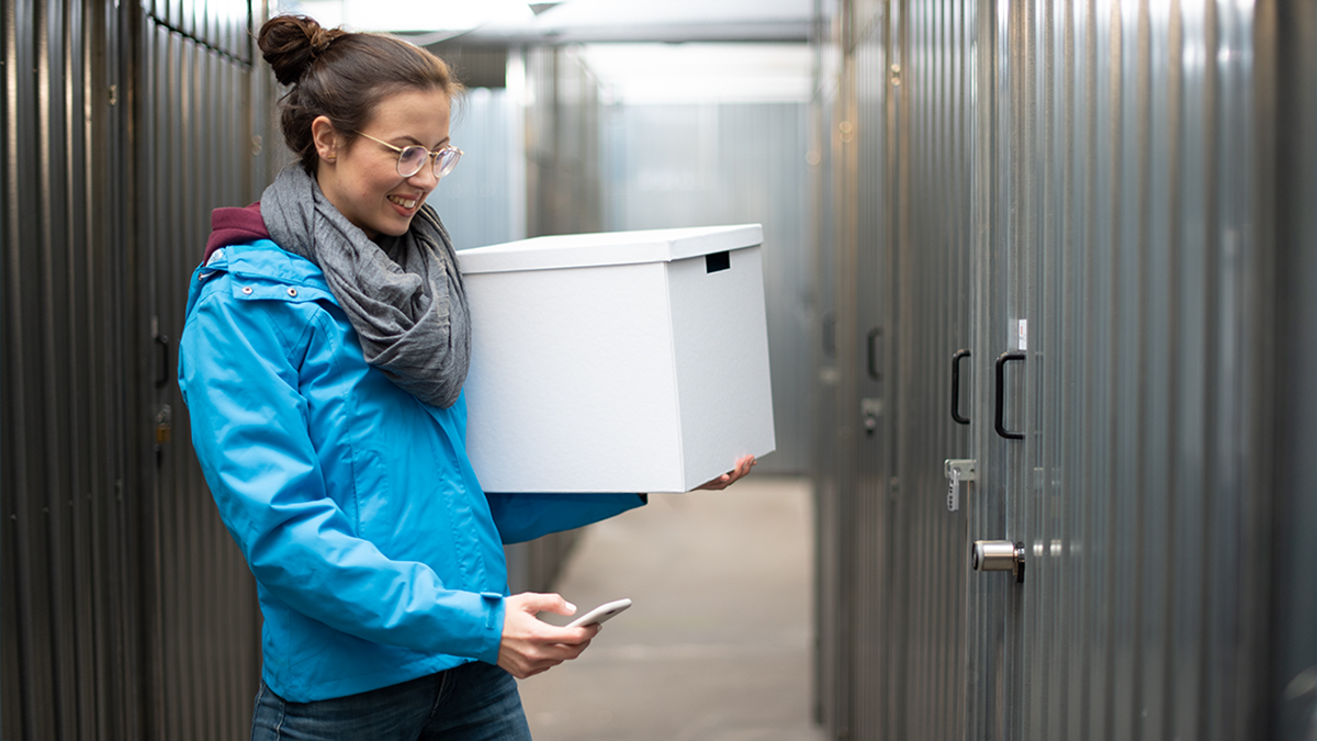 Woman opens storage room with smartphone